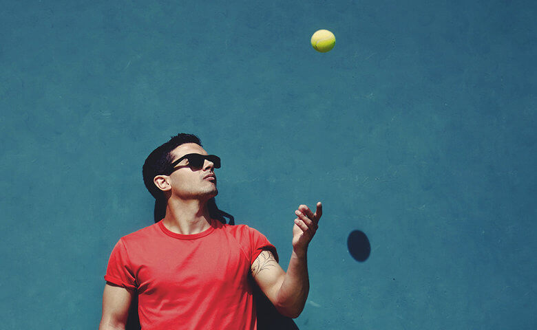 Man juggling a tennis ball