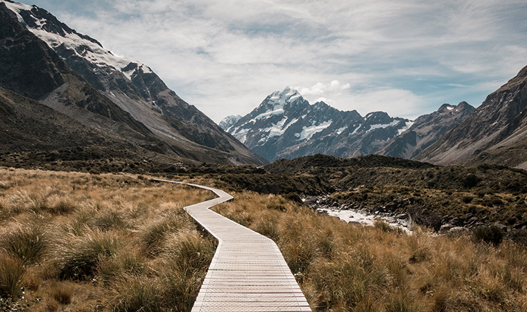 Wooden pathway through mountains.