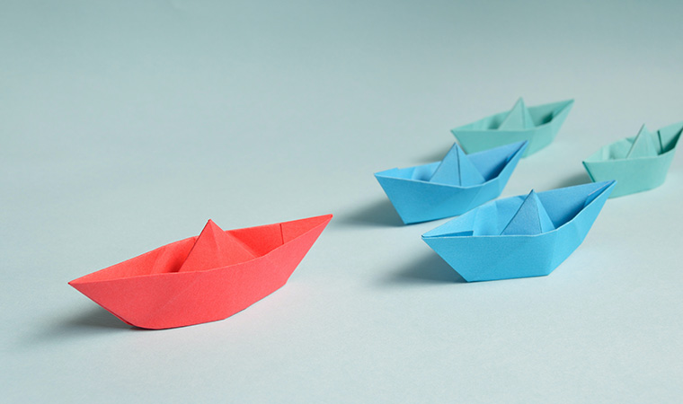 Paper boats on hard surface.