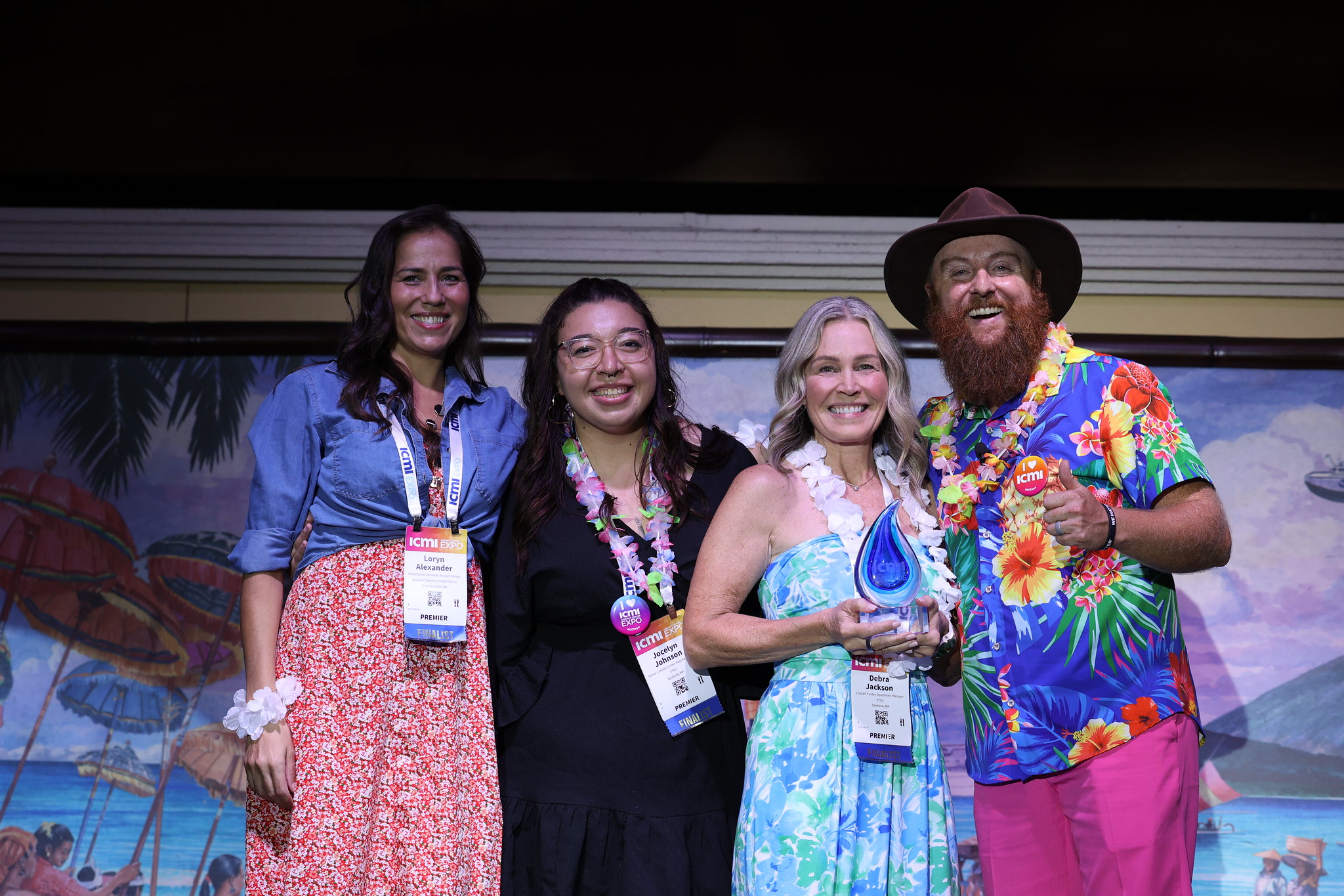 a group of winners accepting their trophy at the ICMI Global Contact Center Awards celebration