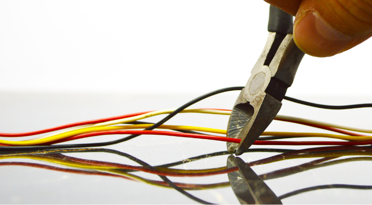 Graphic illustrating someone clipping the wire to defuse a device.