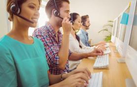 Contact center agents blending sales and service course - people smiling at computers