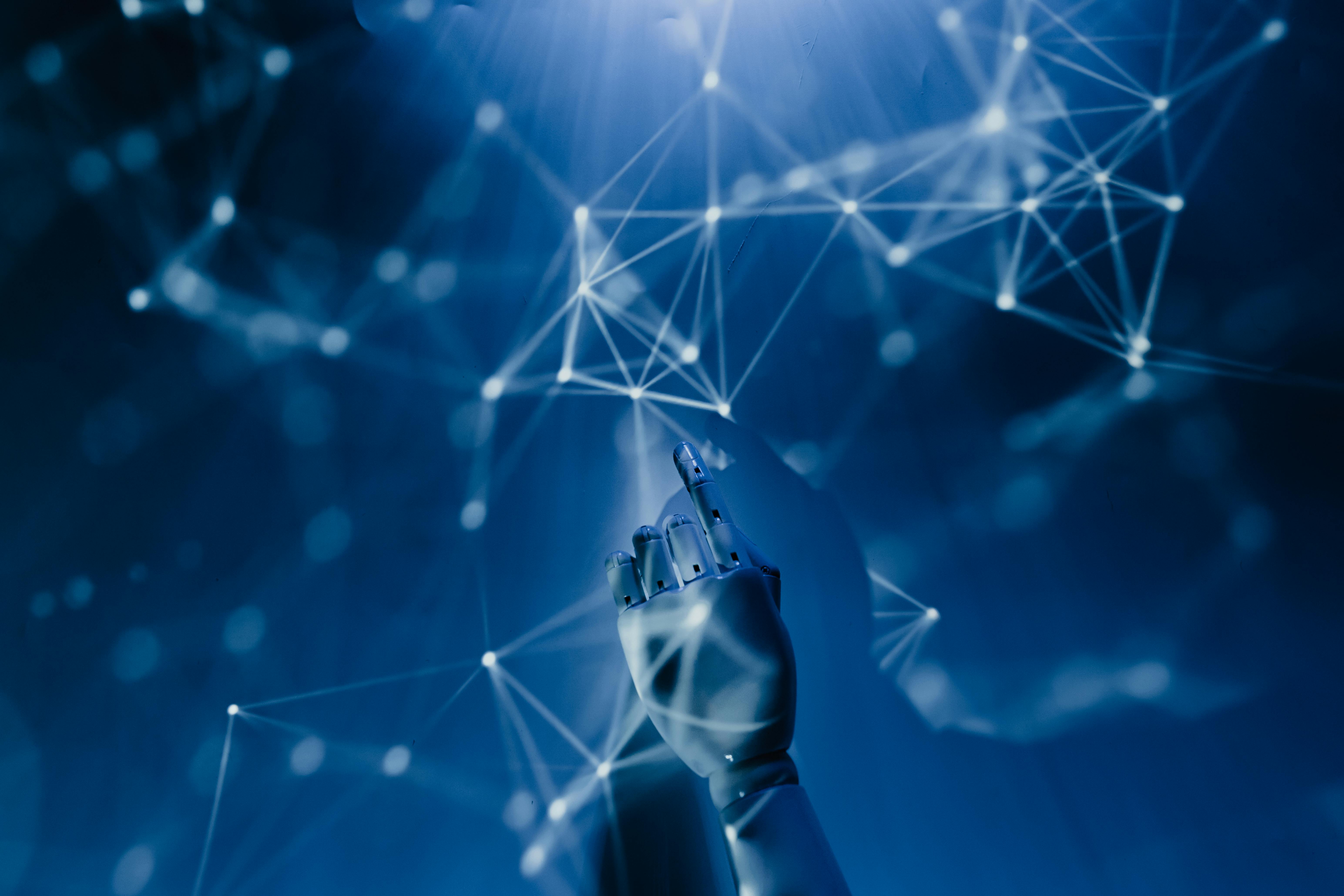 a futuristic photo of a robot's finger pointed to interconnected dots, representing AI