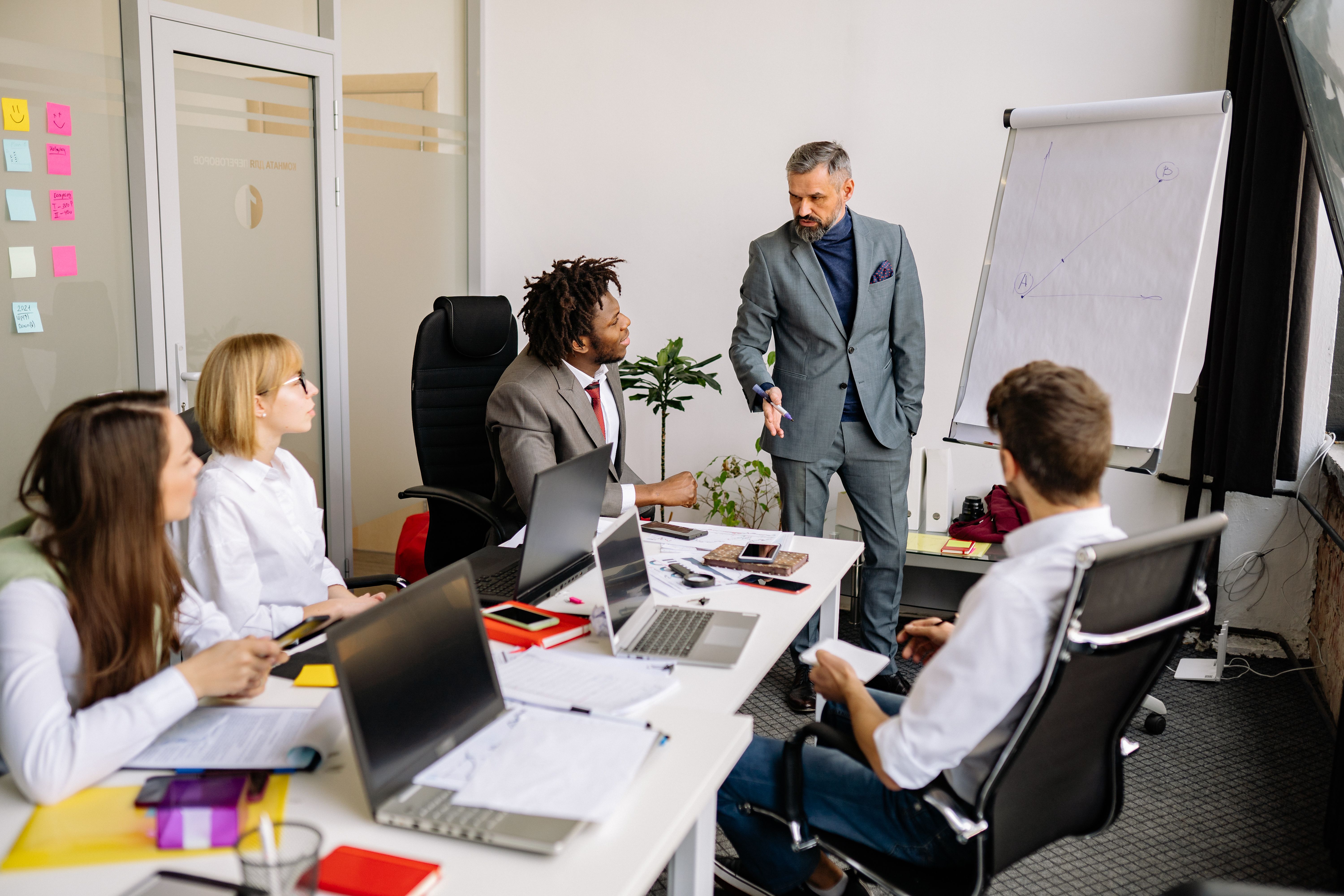 Office team having a meeting in a modern conference room, discussing strategies and collaboration for contact center transformation.