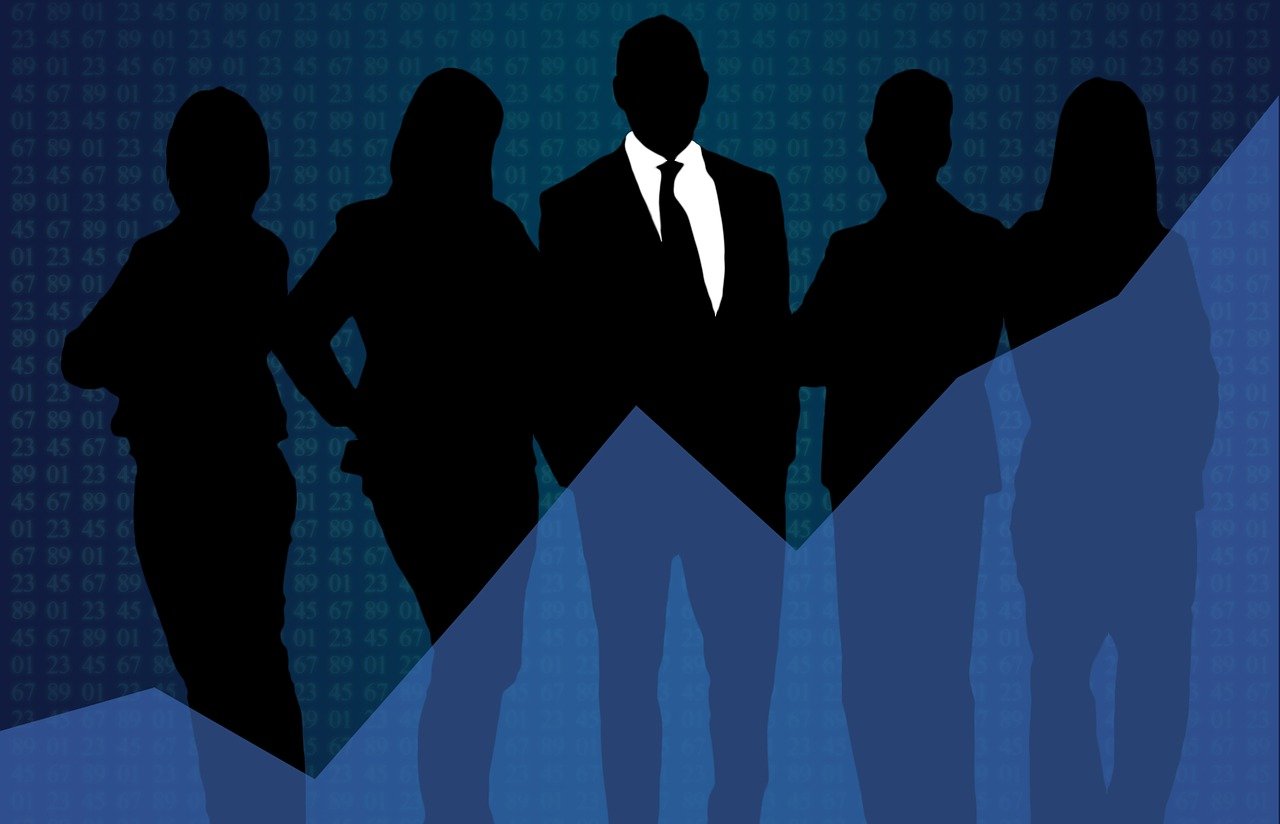 an image of business people with a leader in a suit in the middle