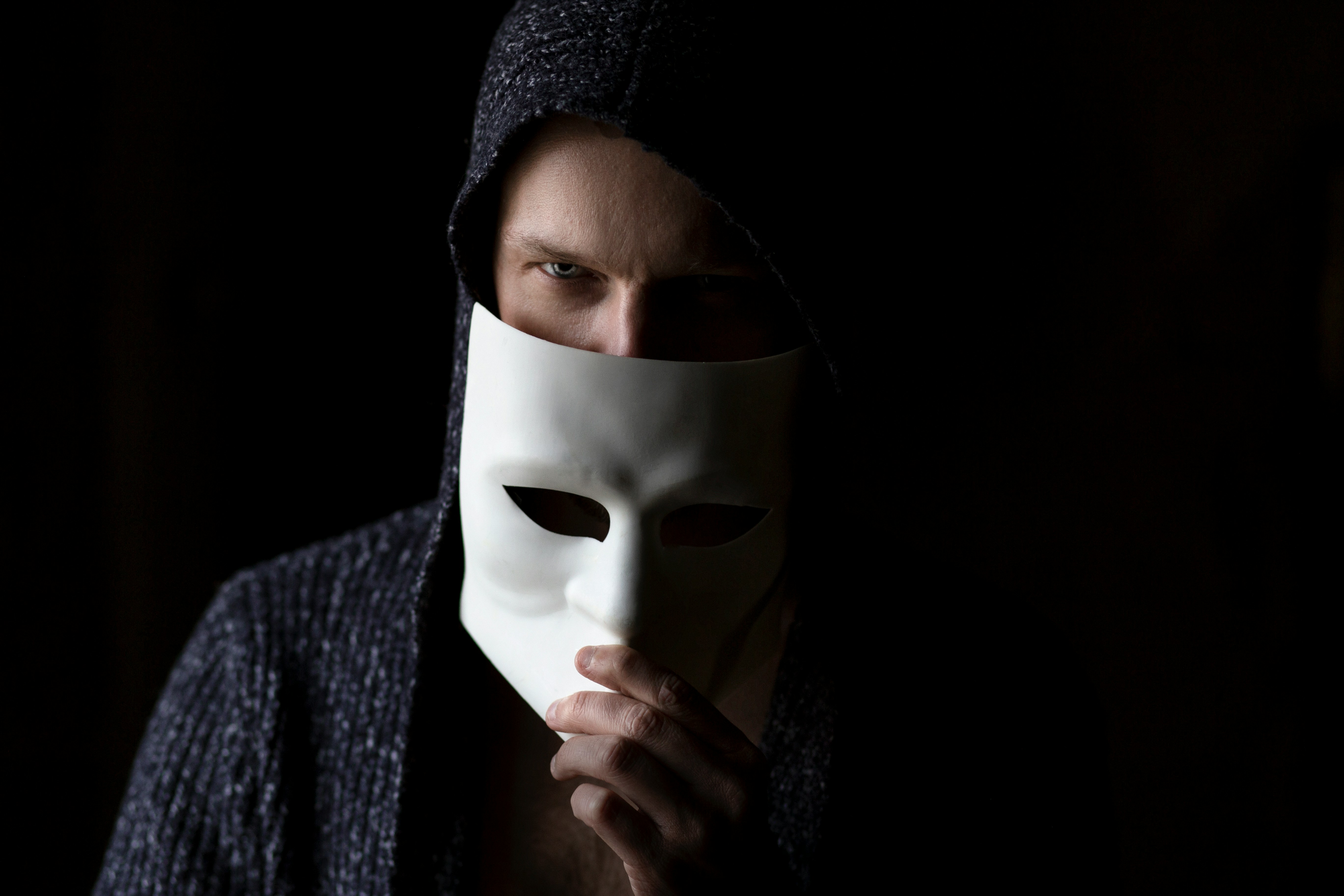 Person wearing a black knit cap and gray sweater, symbolizing reflection and resilience in dealing with workplace energy vampires.