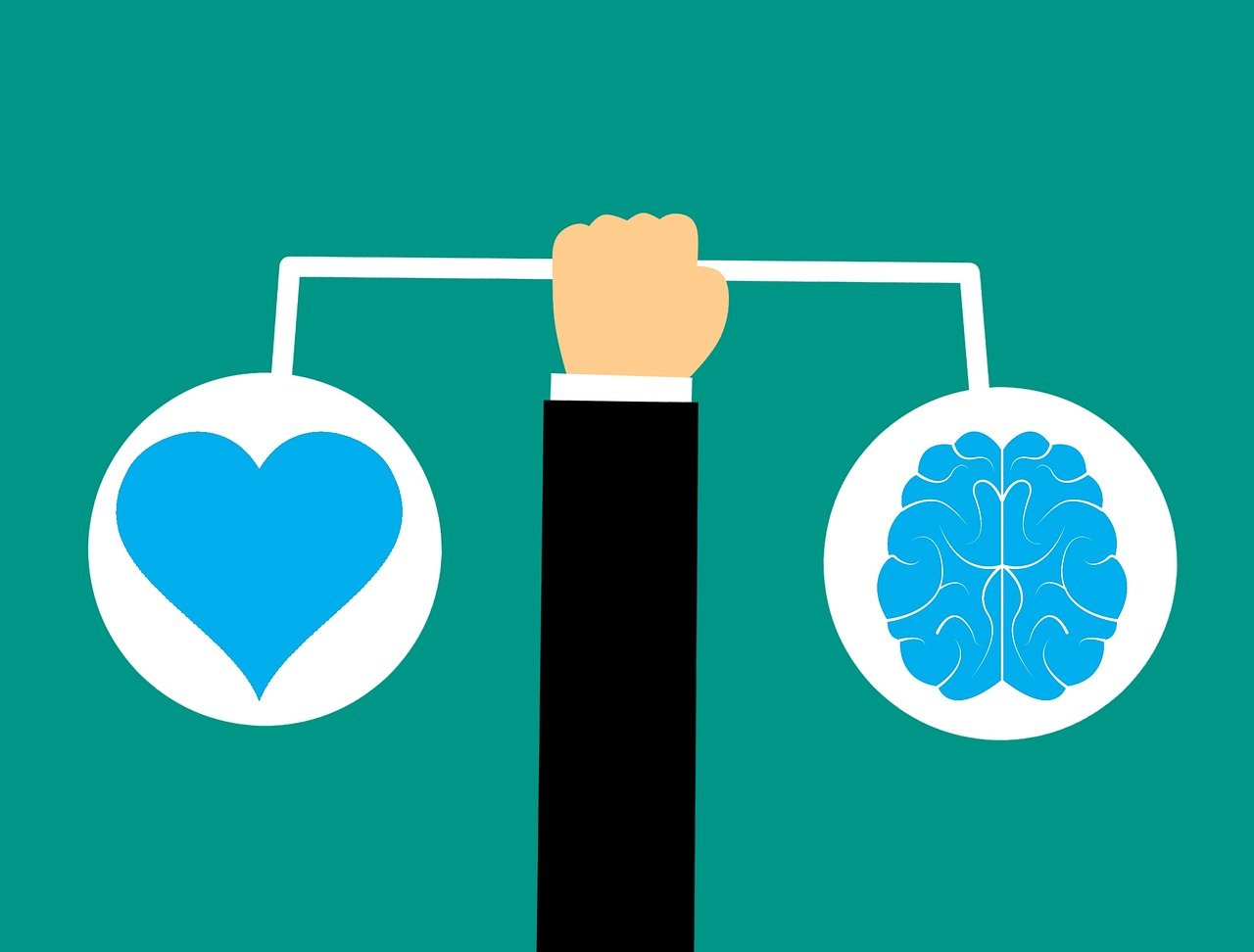 a graphic of a businessman's hand balancing heart and brain