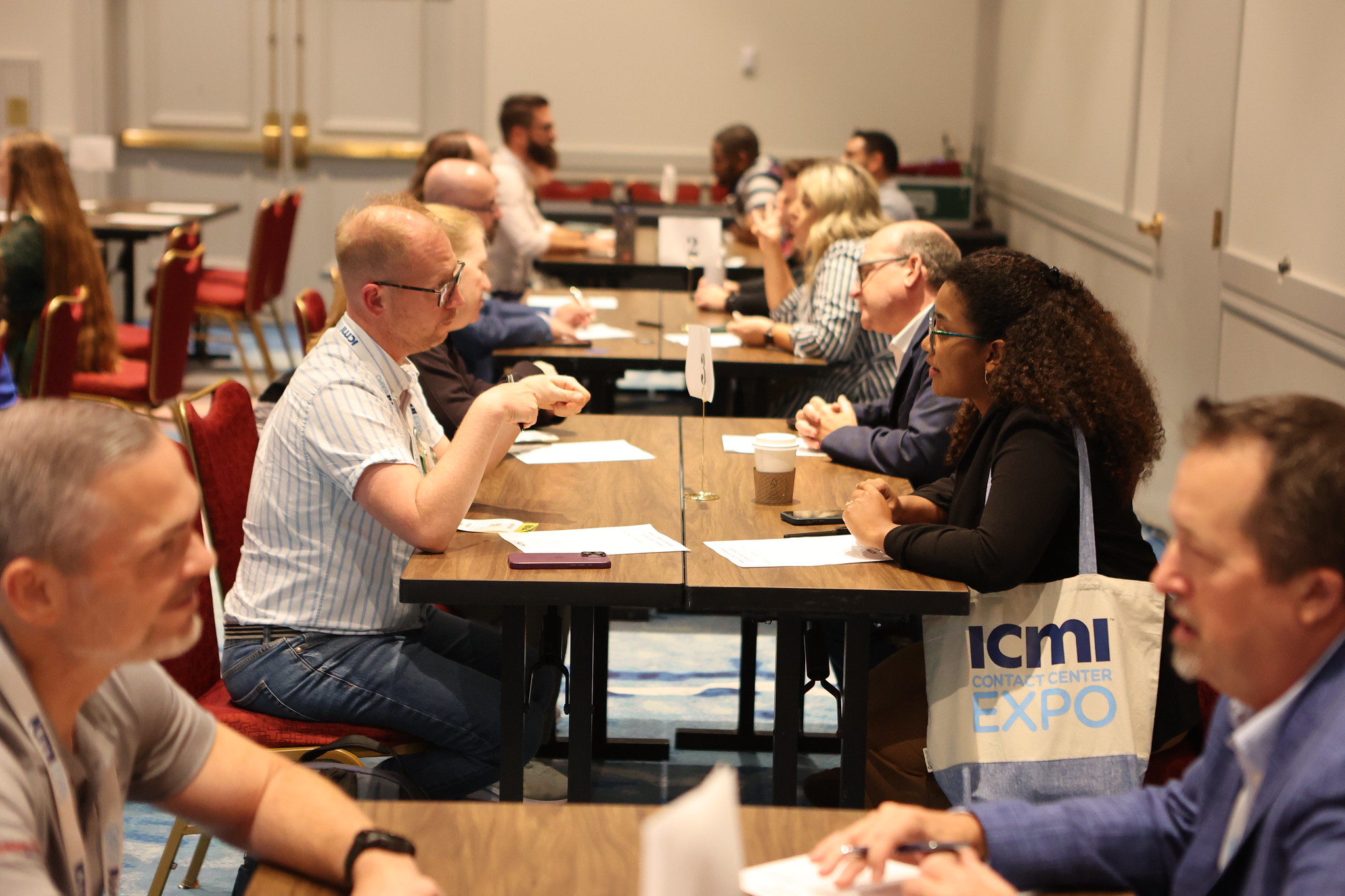 attendees at ICMI Contact Center 2025 participating in a speed networking session