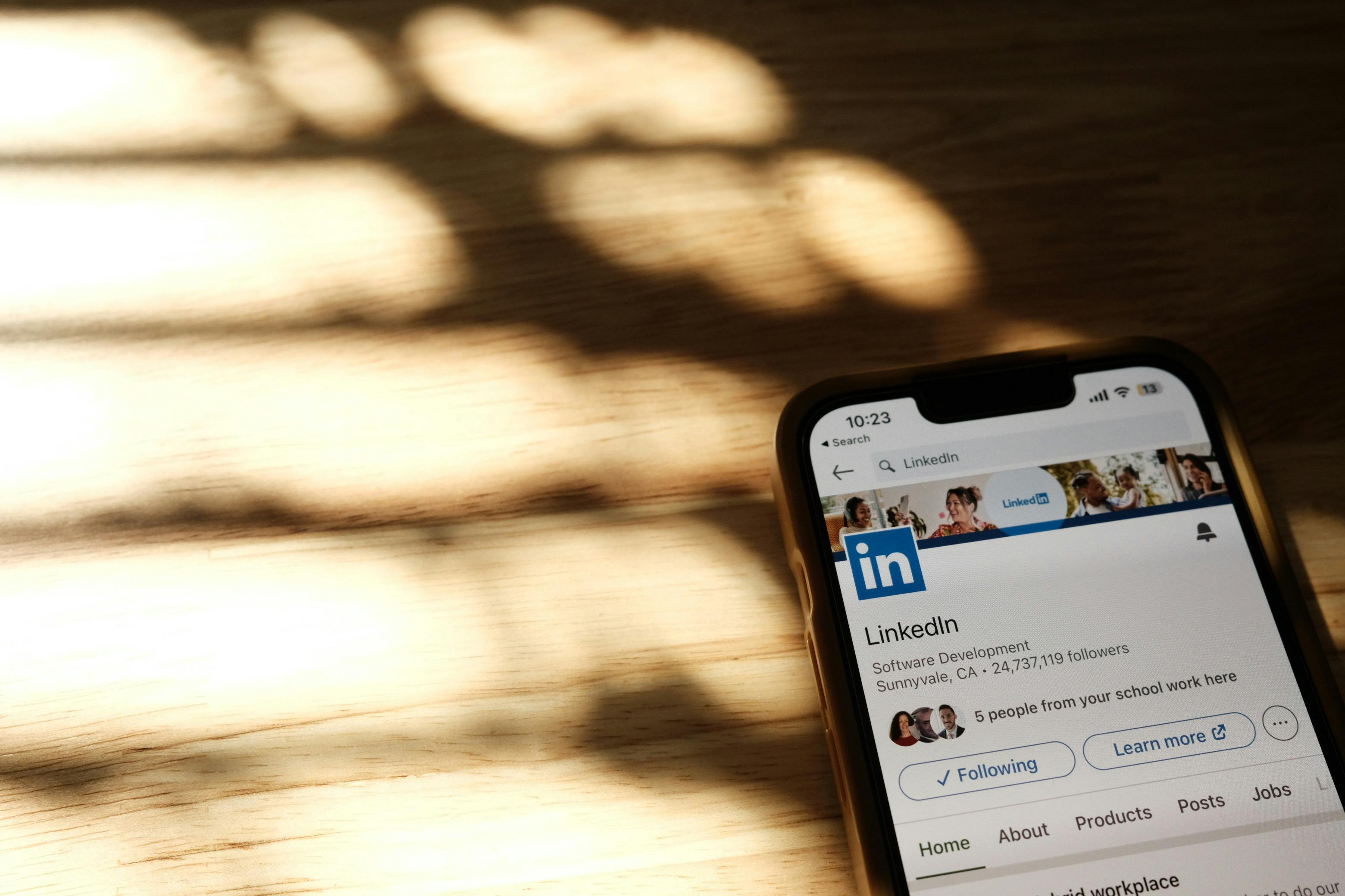 Close-up of a smartphone screen displaying a LinkedIn profile page, symbolizing professional networking and online connections.