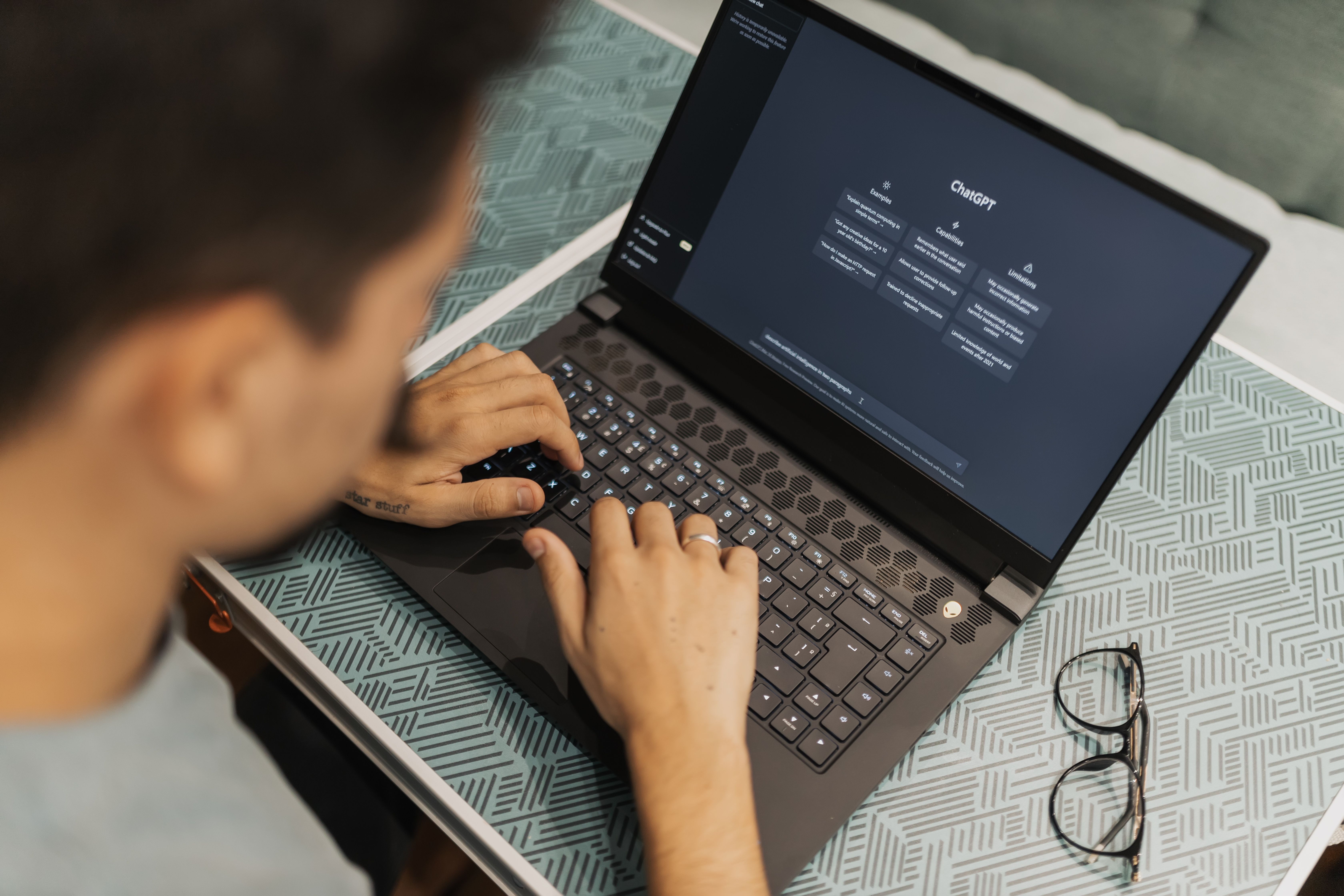 A man using ChatGPT on a laptop, illustrating the practical use of AI tools in the workplace for process improvement, decision support, and team training.