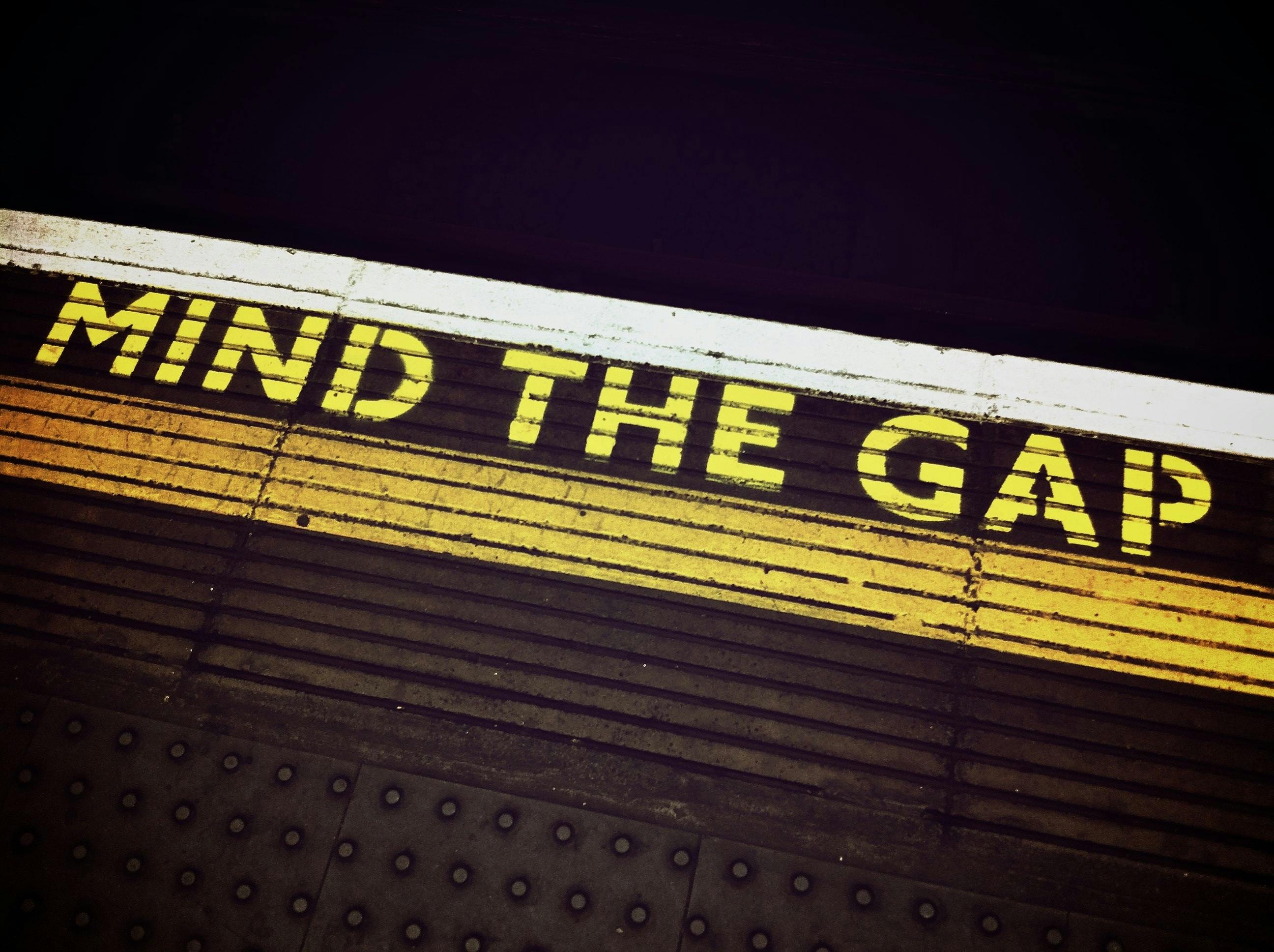Mind the Gap signage symbolizing the importance of addressing workforce readiness in contact center transformation programs.
