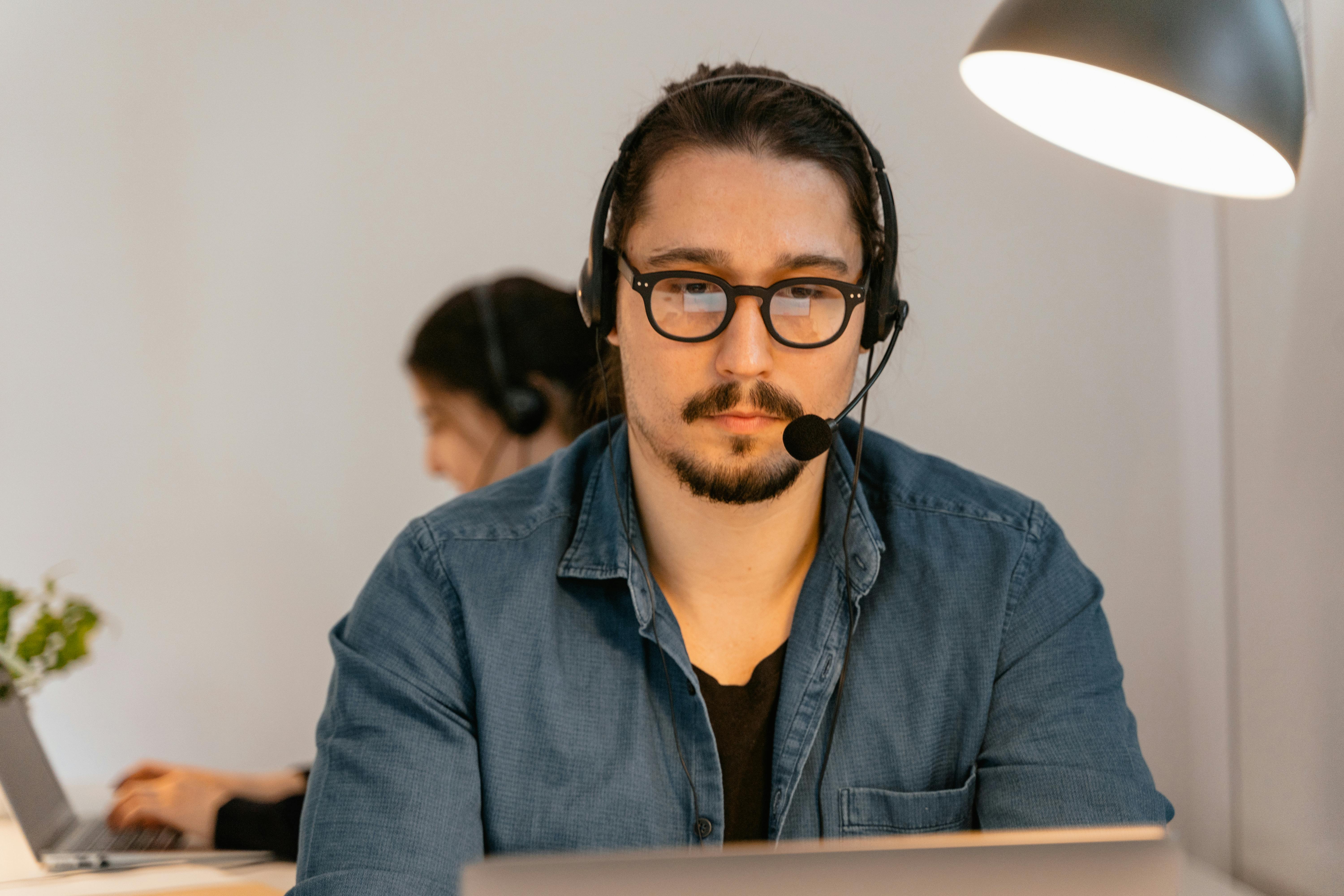 Close-up of a call center agent speaking into a headset with a focused expression