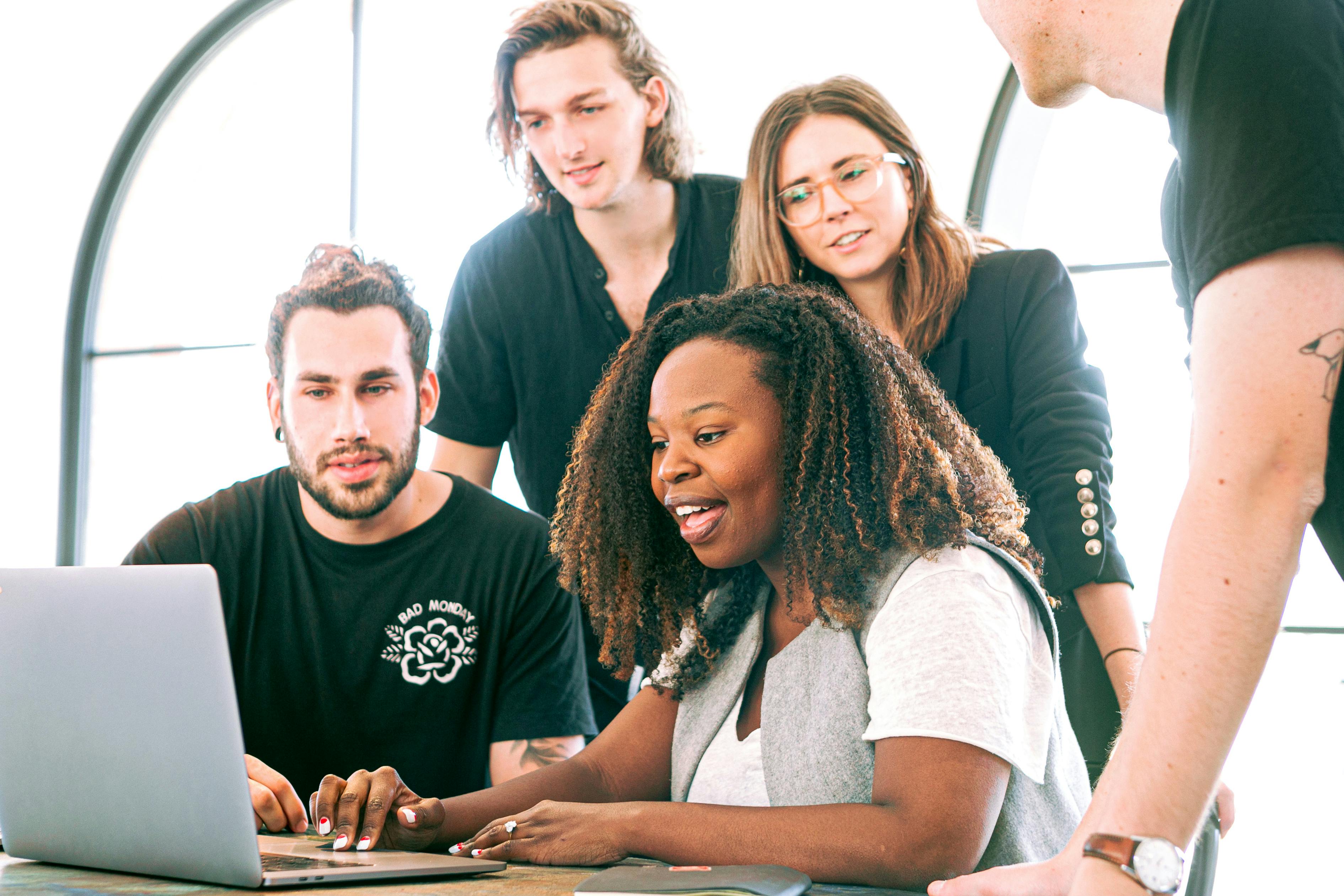 Woman presenting ideas to colleagues during a team meeting, symbolizing psychological safety and collaboration in Workforce Management (WFM)