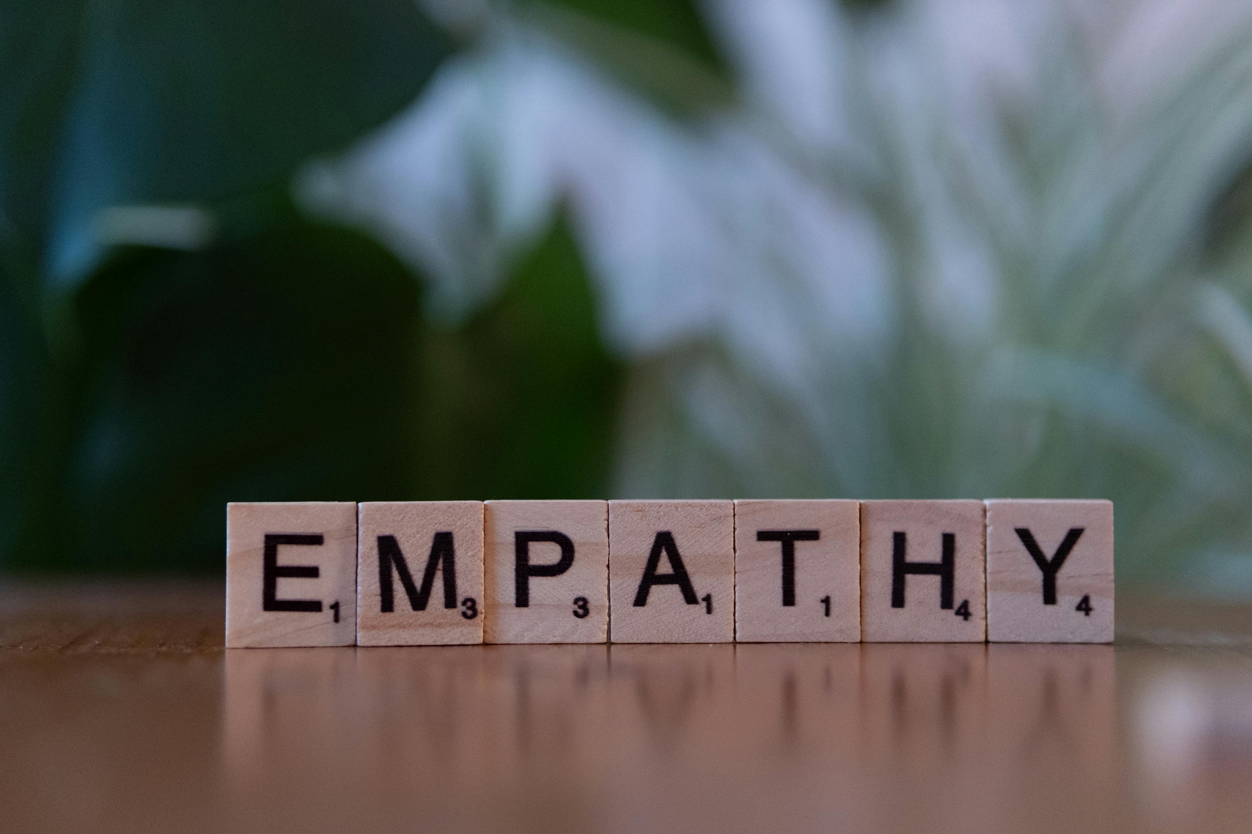 Scrabble tiles that spell the word "empathy"
