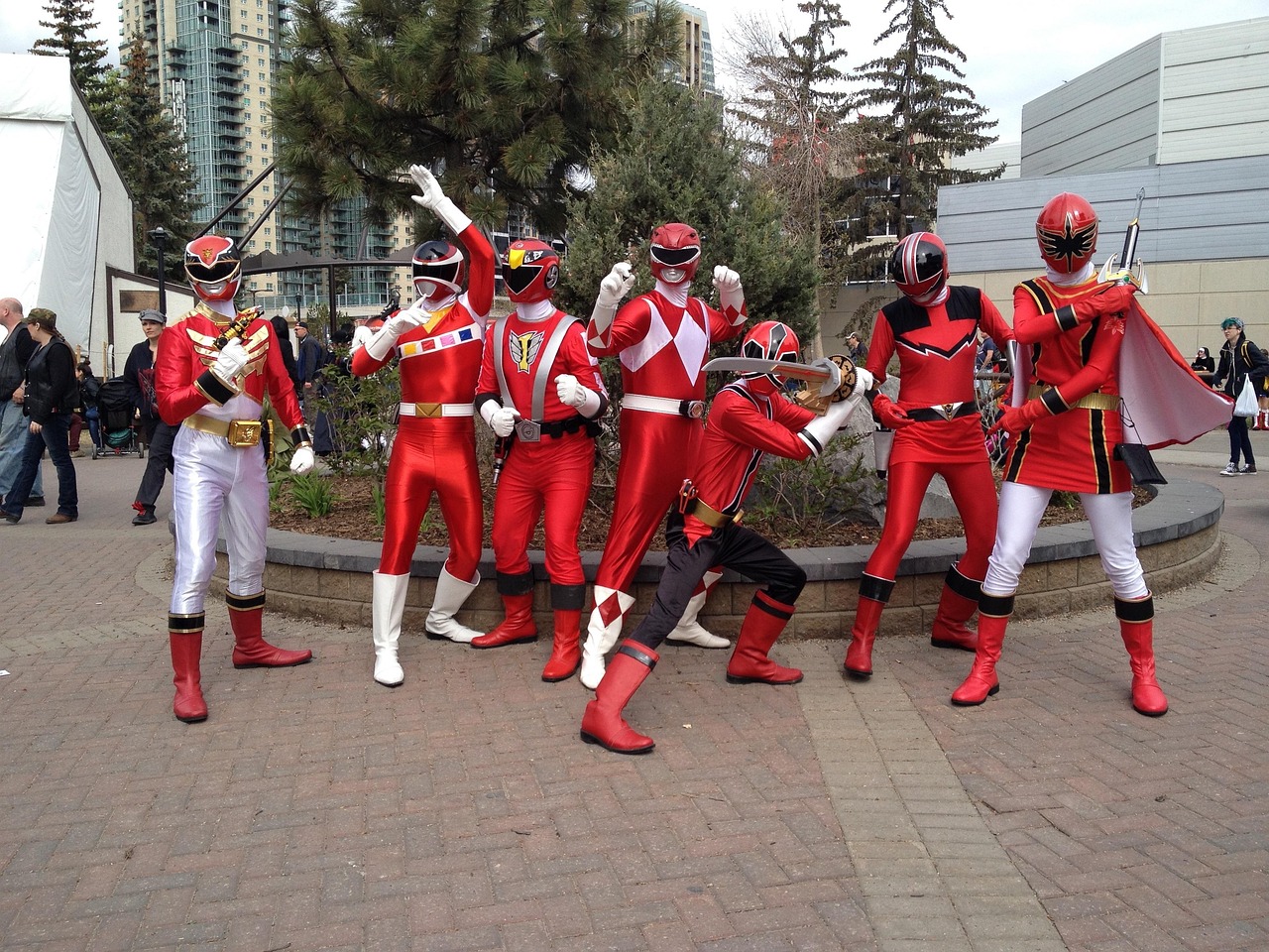 A group of people dressed as superheroes in colorful costumes, standing confidently together, symbolizing teamwork, resilience, and heroism.