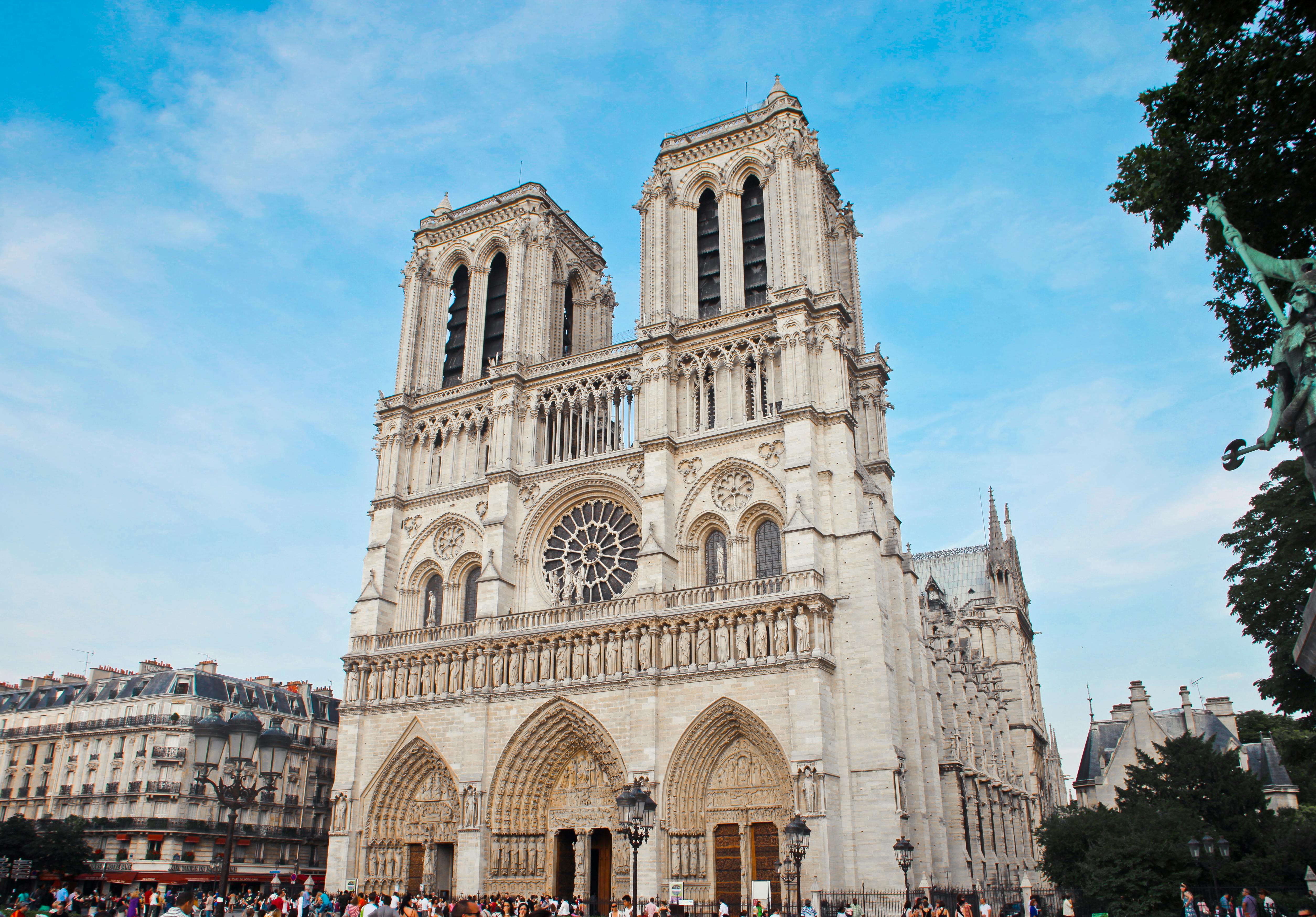 White concrete cathedral building with intricate architectural details under a clear blue sky.