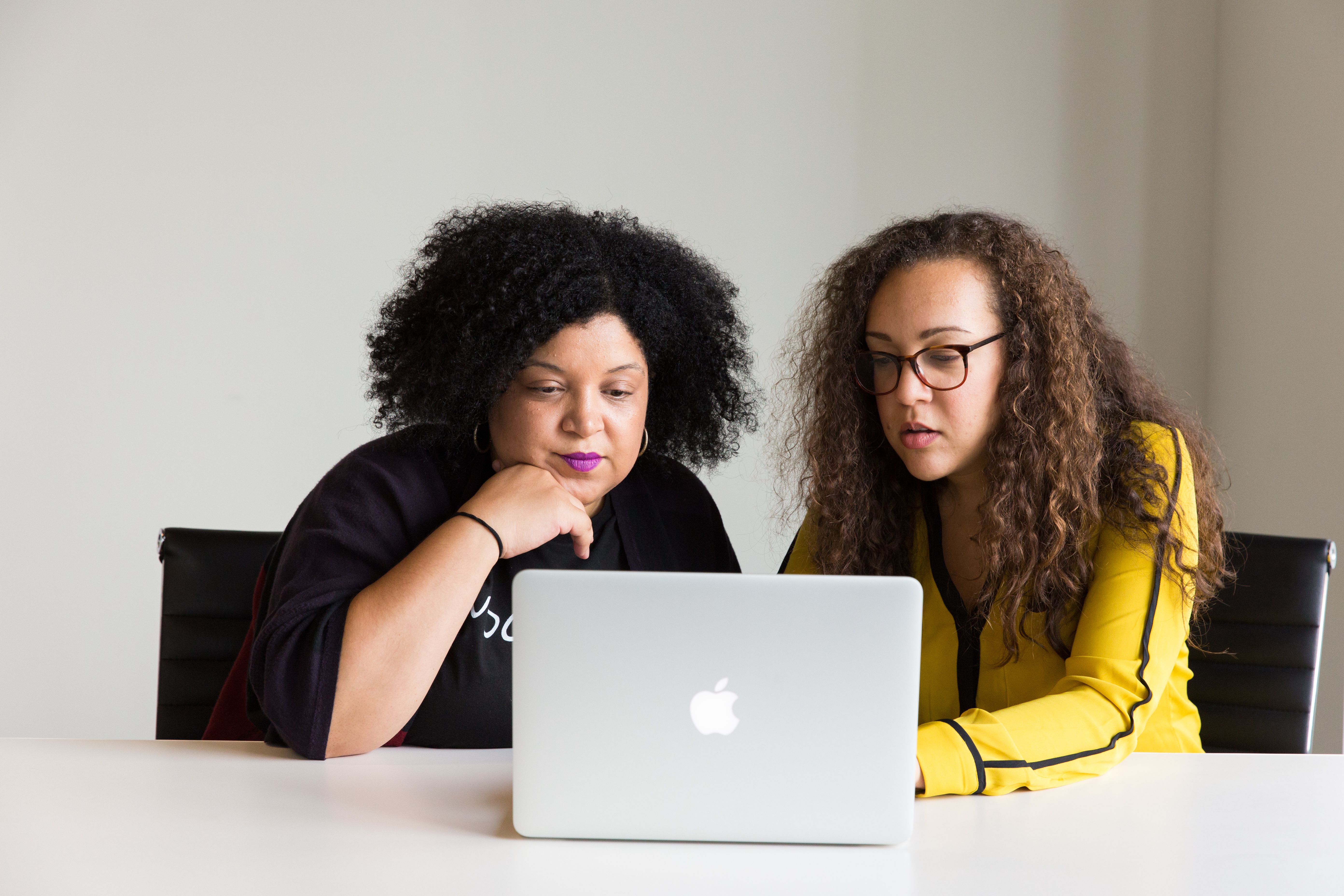A woman using a laptop, symbolizing professional growth and mentorship opportunities, aligning with the ICMI Next Step Collective's focus on career advancement.
