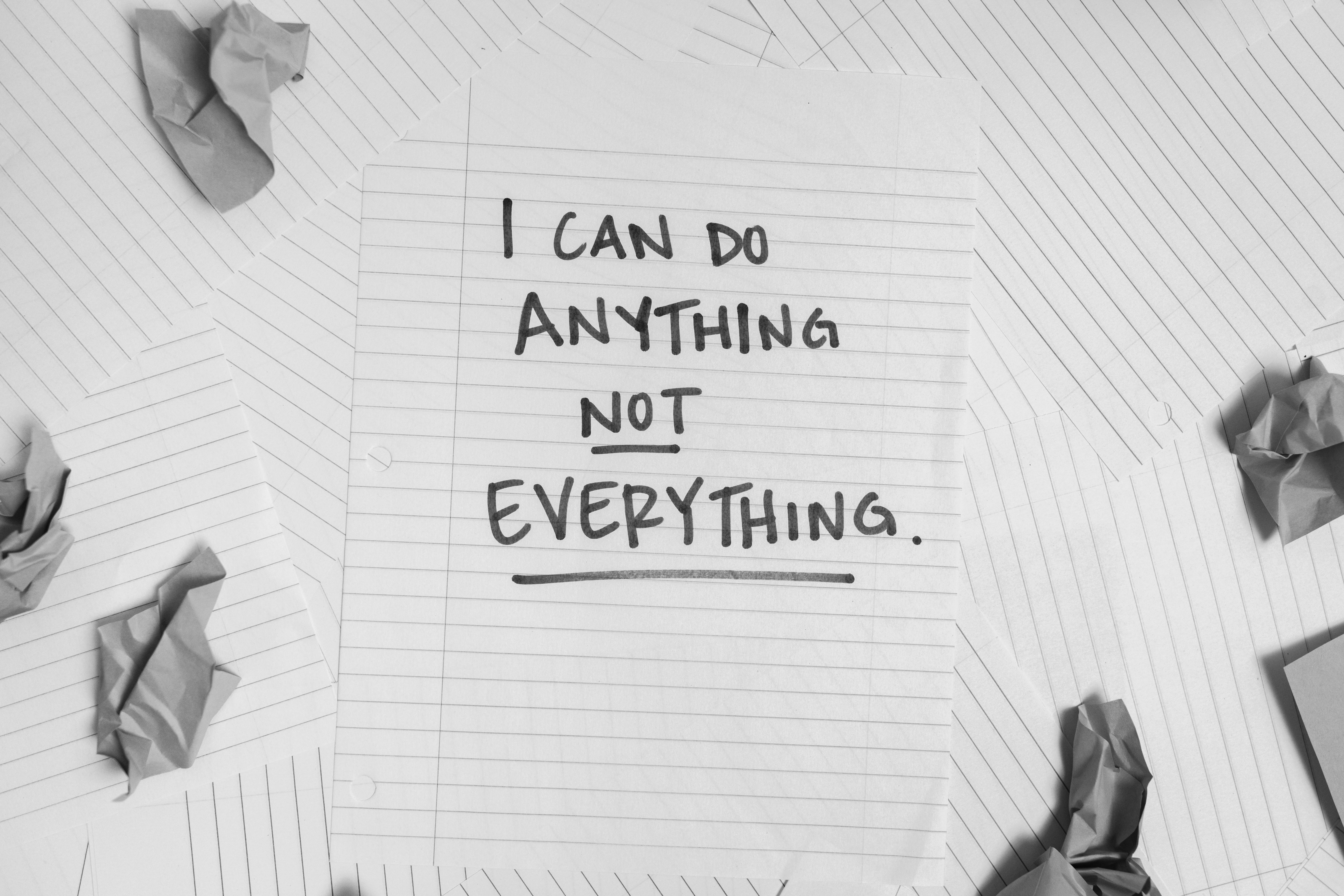  A handwritten note surrounded by crumpled paper that says "I can do anything not everything." 